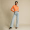 Orange, fitted, long sleeve bodysuit has cutaway detail on front. 
