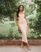 Nude color, figure hugging, long dress has thin adjustable sling and scoop neck. 