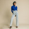 Blue, fitted, long sleeve bodysuit has cutaway detail on front.
