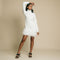 White, turtleneck, long sleeve, knit mini dress featuring feather on front side of hem.